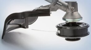 A close-up image of a Honda handheld tool is pictured in a neutral environment. 